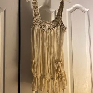 Sheer mesh cream colored tank top blouse with pockets.